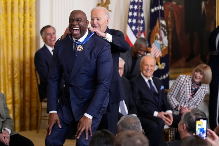 President Joe Biden, right, presents the Presidential Medal of Freedom, the Nation's highest civilian honor, to Earvin "Magic" Johnson in the East Room of the White House.