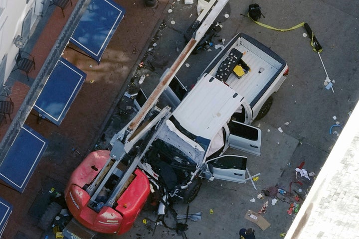 An Islamic State flag lies on the ground rolled up behind the pickup truck that former U.S. Army soldier Shamsud-Din Jabbar drove into a crowd on Bourbon Street in New Orleans on Wednesday, Jan. 1, 2025. The attack killed at least 14 people, with police shooting Jabbar dead after he exited the truck and began shooting.