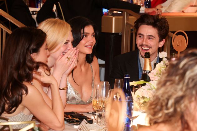 Elle Fanning, Kylie Jenner and Timothée Chalamet sit together at the 82nd Golden Globes on Sunday. Chalamet got roasted by host Nikki Glaser during her opening monologue.