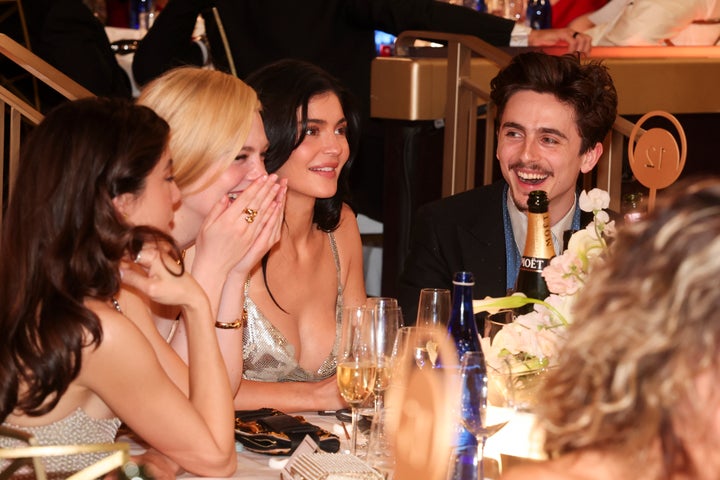 Elle Fanning, Kylie Jenner and Timothée Chalamet sit together at the 82nd Golden Globes on Sunday. Chalamet got roasted by host Nikki Glaser during her opening monologue.