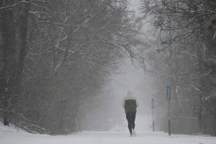 A person runs down a trail during a winter storm on Jan. 5, 2025, in Cincinnati.