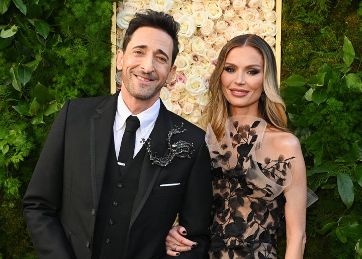 Adrien Brody (left) and Georgina Chapman (right) pose for the cameras at the Golden Globes in Beverly Hills.