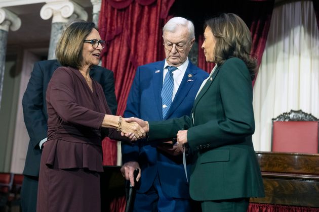 Sen. Deb Fischer (R-Neb.) shakes hands with Vice President Kamala Harris during a swearing-in ceremony at the Capitol on Friday. Bruce Fischer, the senator's husband, refused to shake Harris' hand during the ceremony.