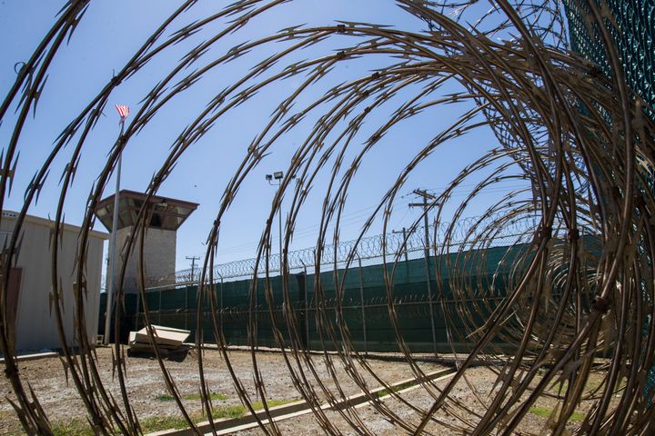 In this April 17, 2019, photo, reviewed by U.S. military officials, the control tower is seen through the razor wire inside the Camp VI detention facility in Guantanamo Bay Naval Base, Cuba.