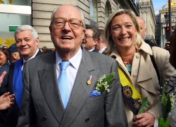 French far-right leader Jean-Marie Le Pen, center, flanked by his daughter Marine Le Pen, and Bruno Gollnisch, arrive for a wreath-laying ceremony at the statue of Joan of Arc, within the party's traditional May Day march on May 1, 2010, in Paris.