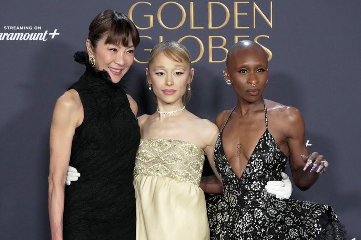 Michelle Yeoh (left), Ariana Grande (center) and Cynthia Erivo (right), winners of Cinematic and Box Office Achievement for "Wicked," pose in the press room at the 82nd Annual Golden Globe Awards.