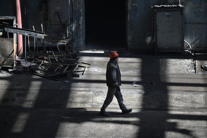 A worker walks past scorched equipments a power plant of energy provider DTEK, destroyed after an attack, in an undisclosed location in Ukraine on April 19, 2024, amid the Russian invasion of Ukraine. 