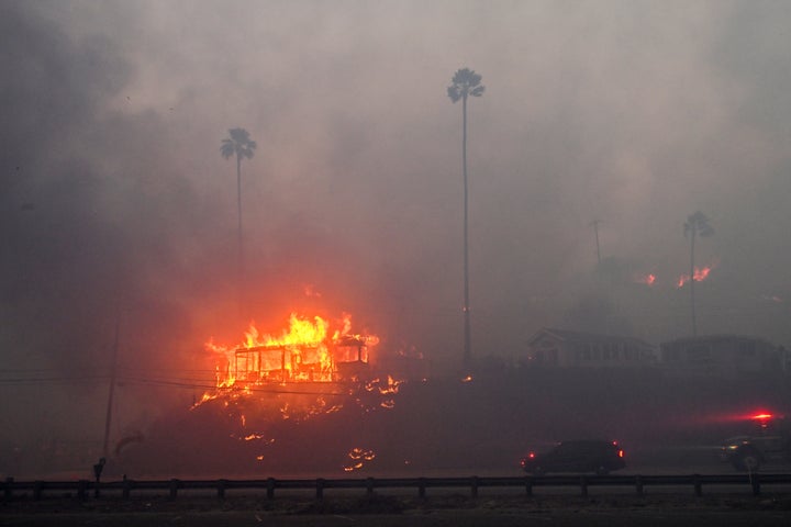 A house is engulfed in flames from the wind-driven Palisades Fire in Pacific Palisades, California.