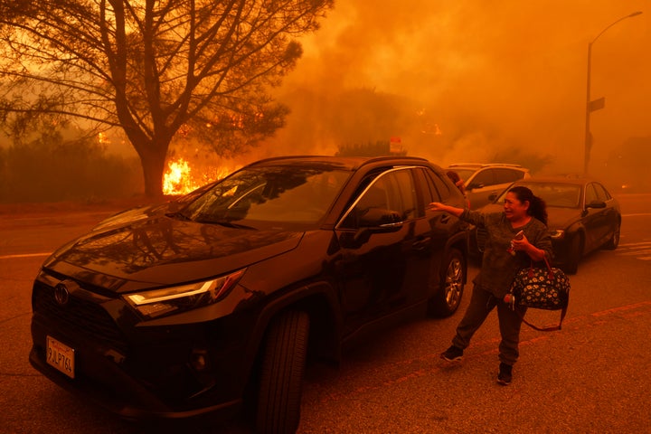 A woman cries as the Palisades Fire advances. (AP Photo/Etienne Laurent)