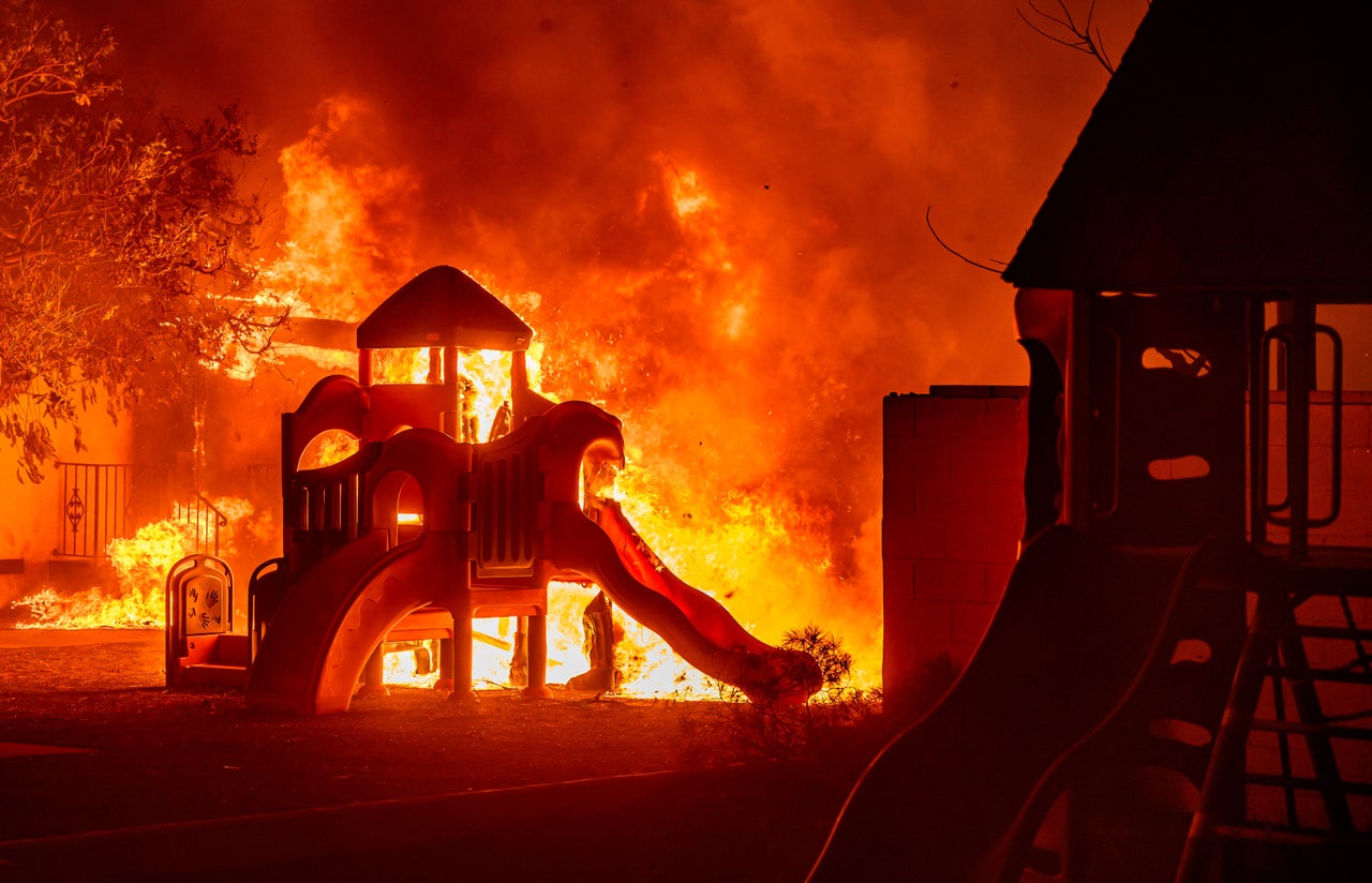 A playground burns in a residential neighborhood during the Eaton Fire in Pasadena on Tuesday.