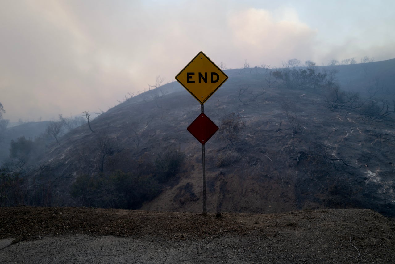 A sign is seen near a hillside that burned during the Palisades Fire on Tuesday.