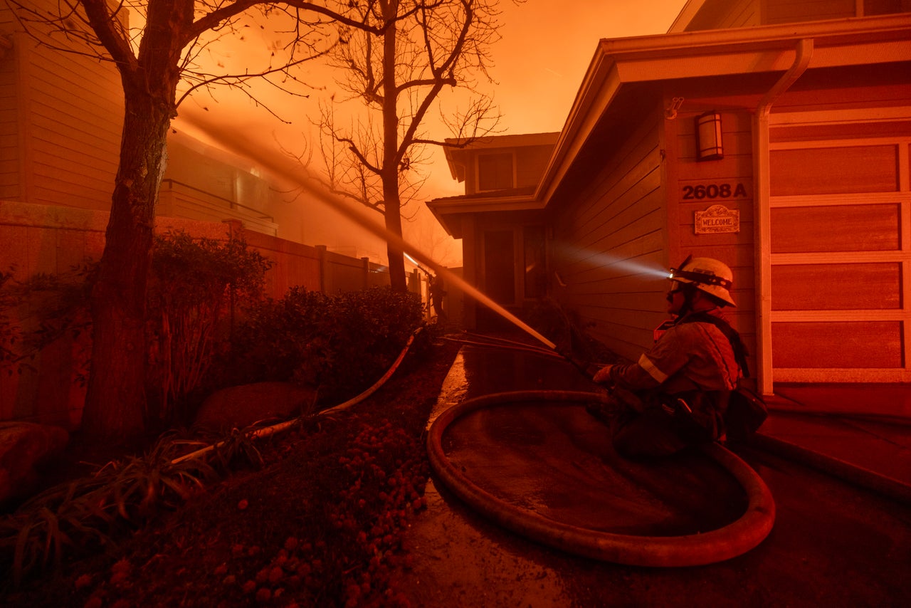 Firefighters battle the Eaton Fire in Pasadena on Tuesday.