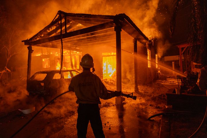 ALTADENA, CALIFORNIA - JANUARY 8: Firefighters battle the Eaton Fire on January 8, 2025 in Altadena, California. Powerful Santa Ana winds pushed the fire across more than 10,000 acres in less than 24 hours, destroying potentially hundreds of homes and killing five people so far. At least 1,000 structures have burned and 70,000 people are forced from their homes in the Los Angeles area as multiple dangerous wildfires continue to erupt. (Photo by David McNew/Getty Images)