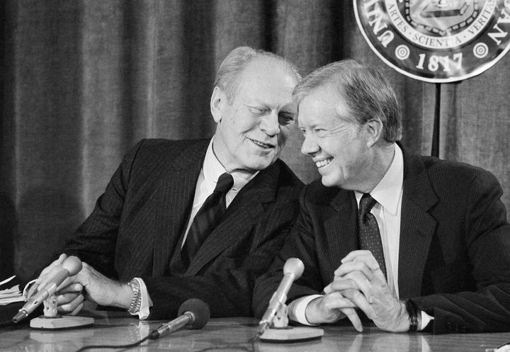 Former Presidents Gerald Ford (left) and Jimmy Carter share a light moment as they take a break during a talk with reporters in 1984.