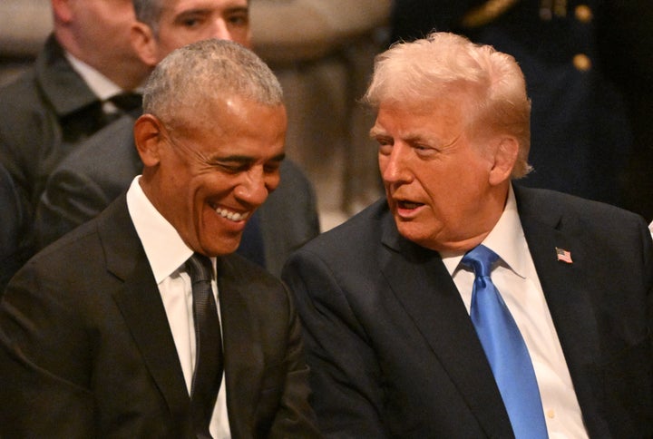 Former President Barack Obama speaks with President-elect Donald Trump before the State Funeral Service for former President Jimmy Carter at the Washington National Cathedral in Washington, D.C., on Jan. 9, 2025.