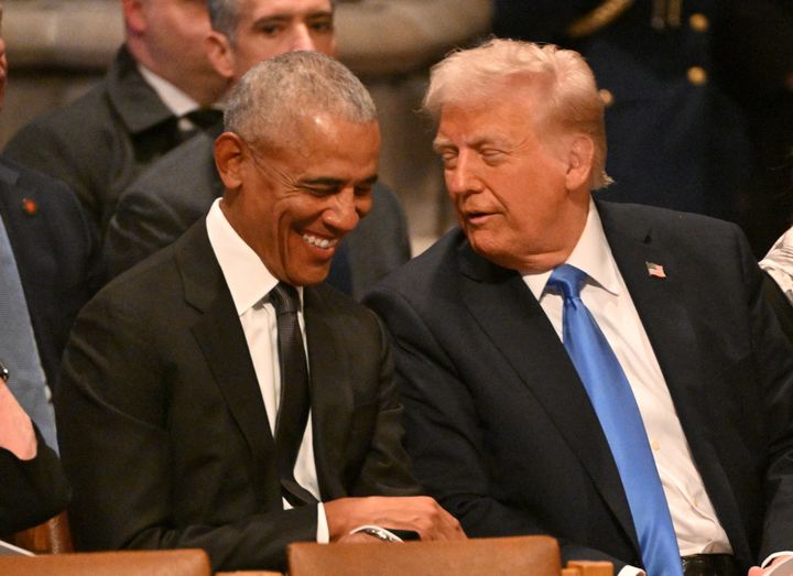 Former US President Barack Obama speaks with President-elect Donald Trump before the State Funeral Service for former US President Jimmy Carter at the Washington National Cathedral in Washington, DC, on January 9, 2025.