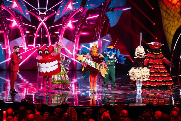 Joel Dommett with the stars of The Masked Singer season six