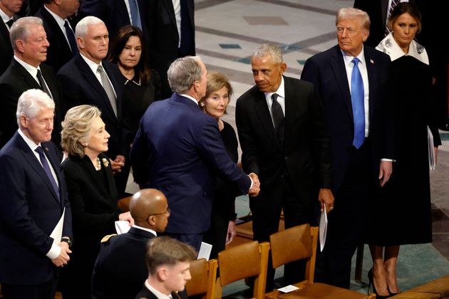 Barack Obama greets George W. Bush following the state funeral for former President Jimmy Carter at Washington National Cathedral.