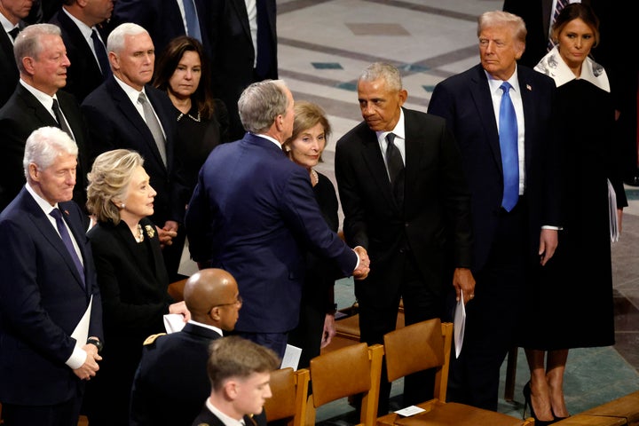 Barack Obama greets George W. Bush following the state funeral for former President Jimmy Carter at Washington National Cathedral.