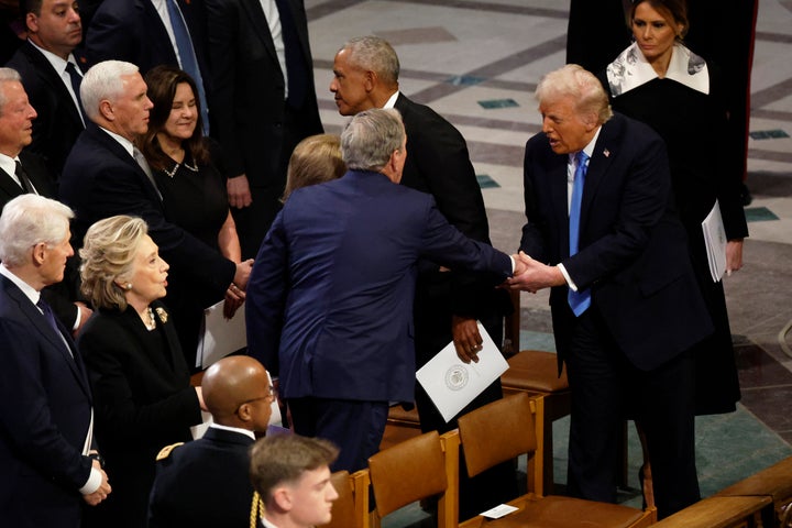 George W. Bush greets Donald Trump following the state funeral.