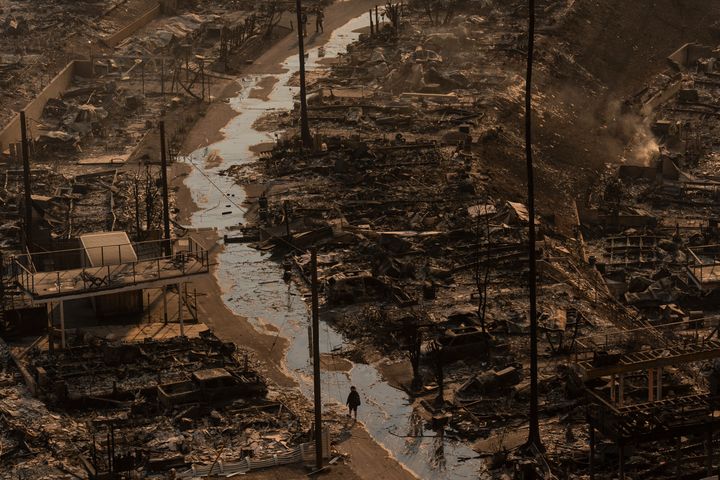 A person walks amid the destruction left behind by the Palisades Fire in the Pacific Palisades neighborhood of Los Angeles on Thursday.