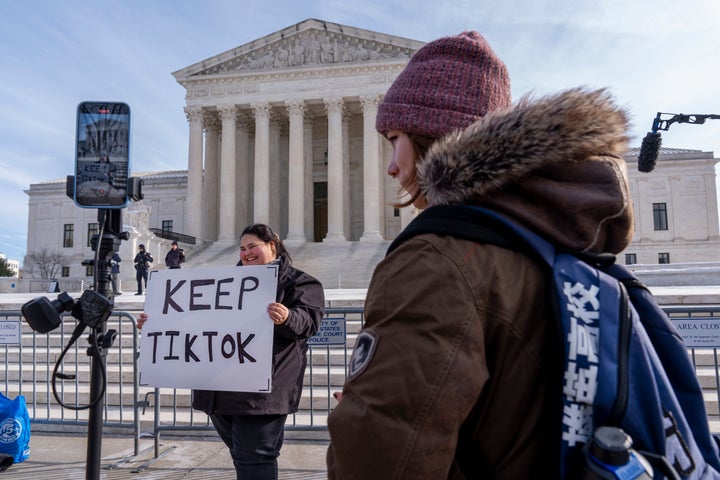 Callie Goodwin, of Columbia, South Carolina, holds a sign Friday in support of TikTok outside the Supreme Court in Washington, D.C. Goodwin, a small-business owner who sells personalized greeting cards, says 80% of her sales come from people who found her on TikTok.