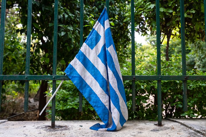 Athens, Greece. November 2021. a Greek flag on the railing of a fence