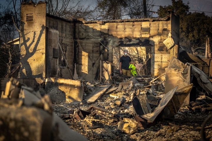 A former homeowner in the Altadena neighborhood walks through the rubble of his house. 