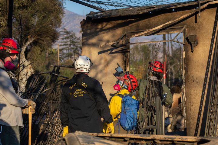 ALTADENA CALIFORNIA - JANUARY 11: Search and rescue team members search the ruins of one of the thousands of homes that were destroyed by the Eaton Fire on January 11, 2025 in Altadena, California. At least eight people are confirmed to have died in the Eaton Fire so far. More than 7,000 structures were damaged or destroy when powerful Santa Ana winds spread the fire across more than 10,000 acres and far into the city in less than 24 hours. At least 15 people have been arrested for looting. (Photo by David McNew/Getty Images)