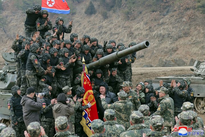 North Korean leader Kim Jong Un, center, meets soldiers who took part in a training in North Korea, on March 13, 2024