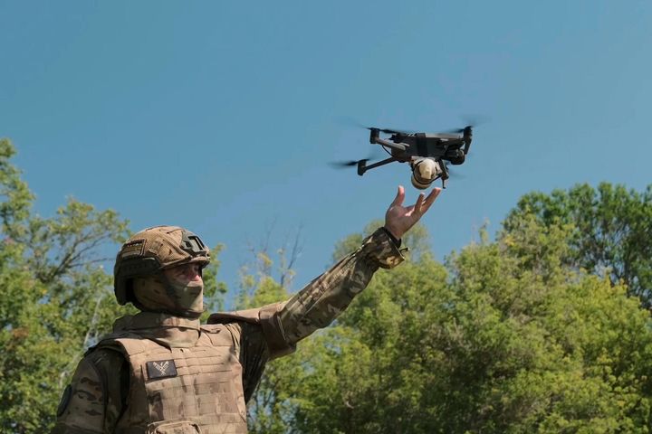 A Russian serviceman launches a drone at an undisclosed location in Ukraine. (Russian Defense Ministry Press Service via AP)