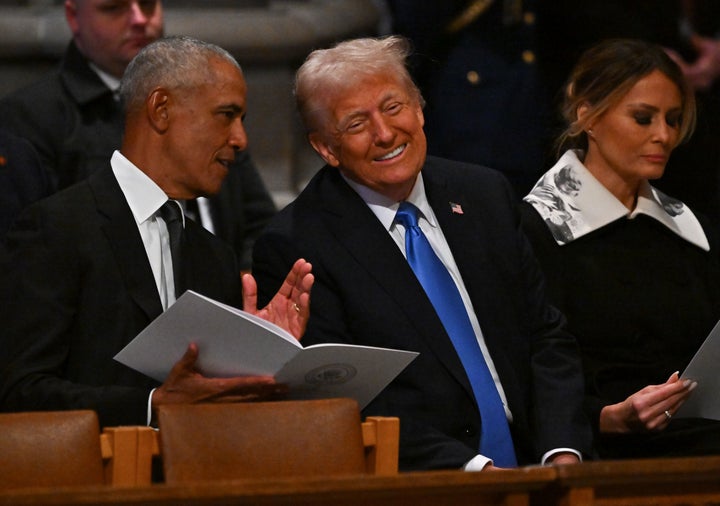 Barack Obama and Donald Trump speak while attending Jimmy Carter's funeral service in Washington, D.C. 