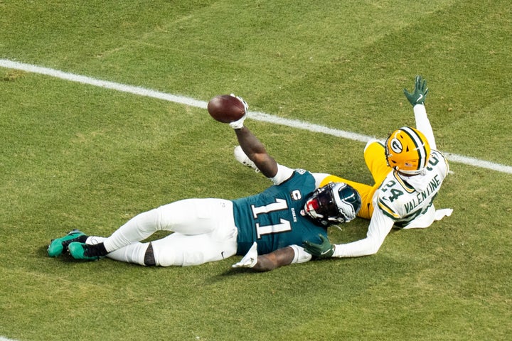 Brown holds up the ball after making the catch against Green Bay in a playoff game on Sunday.