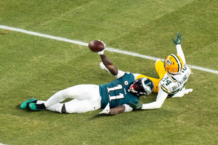 Brown holds up the ball after making the catch against Green Bay in a playoff game on Sunday. 