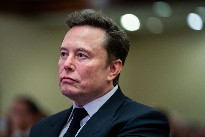 Elon Musk listens as President-elect Donald Trump speaks during a meeting with the House GOP conference, Wednesday, Nov. 13, 2024, in Washington.