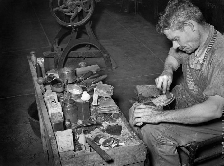 A cobbler works at Boot Shop in Alpine, Texas, in 1939.