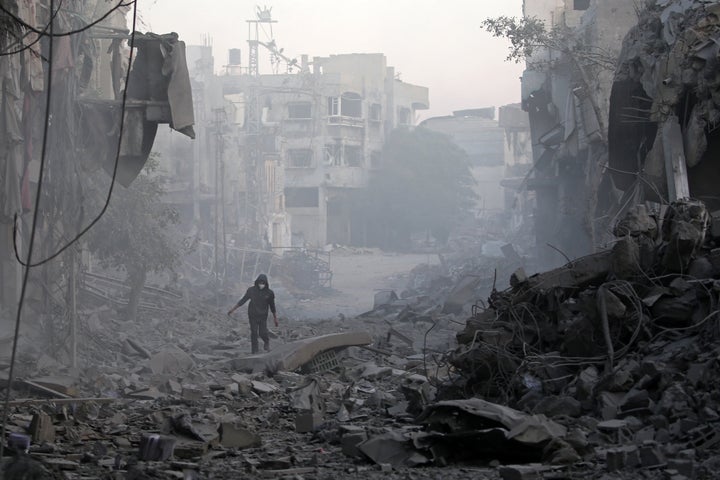 What Are The Obstacles To A Ceasefire-Hostage Deal Between Hamas And Israel? 3 A Palestinian man walks through the rubble of buildings destroyed in Israeli airstrikes at the Bureij refugee camp in the central Gaza Strip, on Jan. 12, 2025.