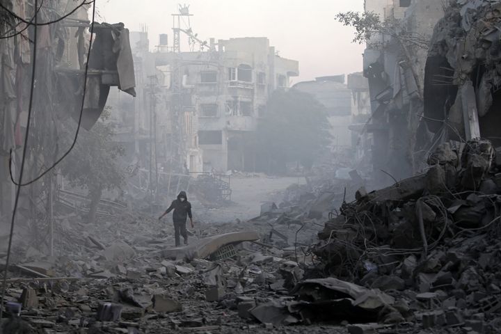 A Palestinian man walks through the rubble of buildings destroyed in Israeli airstrikes at the Bureij refugee camp in the central Gaza Strip, on Jan. 12, 2025.