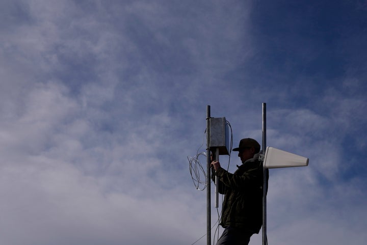 A man installs cloud-seeding equipment in 2022 in Lyons, Colorado.