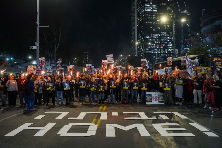 Demonstrators hold torches during a protest calling for the immediate release of the hostages held in the Gaza Strip by the Hamas militant group in Tel Aviv, Israel, on Jan. 13, 2025.