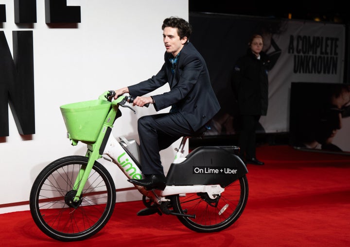 Timothée Chalamet arrives to the London premiere of "A Complete Unknown" on an e-bike Tuesday.