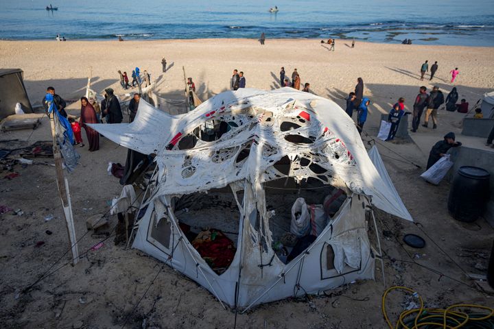 Palestinians inspect the site of an Israeli army strike early Tuesday morning in Deir Al-Balah in the central Gaza Strip.