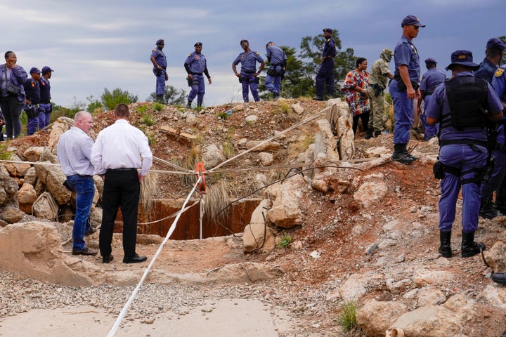 The miners have languished in the mine for over two months. Police officers and private security personnel are seen at the mine's opening on Nov. 15.