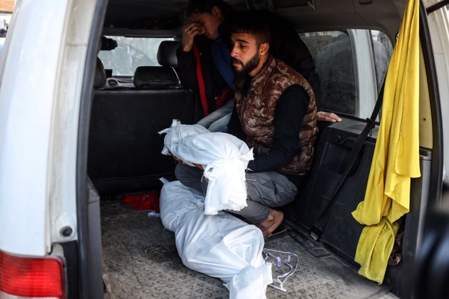 Mourners sit in a vehicle on Jan. 15 with the bodies of victims killed by an Israeli air strike in Deir el-Balah, Gaza. Israel has killed more than 46,000 Palestinians in its war against Hamas.