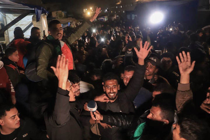 Palestinians celebrate the imminent announcement of a ceasefire deal between Hamas and Israel in Khan Younis, central Gaza Strip.