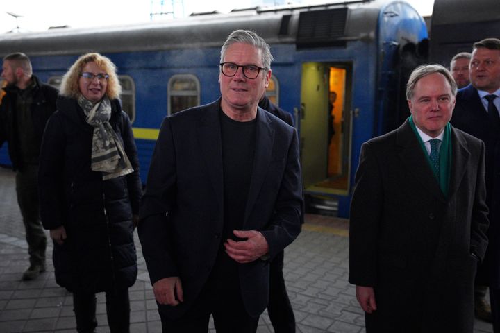 Keir Starmer is greeted by Ukrainian officials and the British ambassador to Ukraine, Martin Harris, front right, as he arrives at a train station in Kyiv.