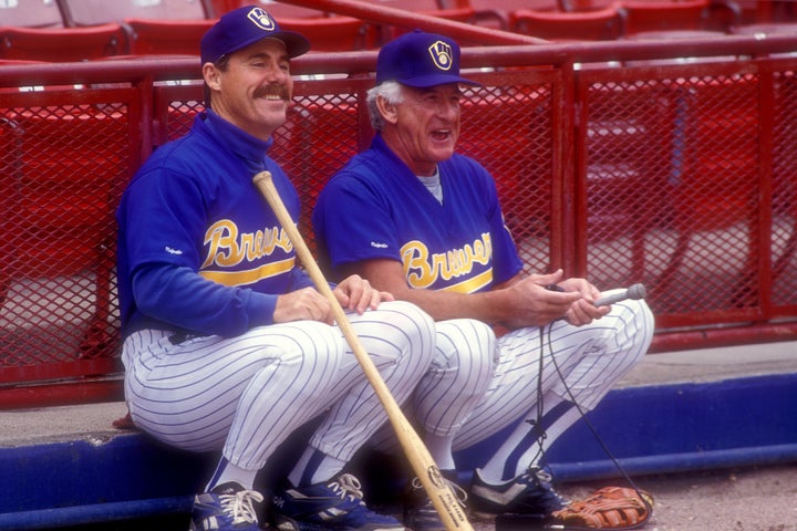 Sportscaster Bob Uecker, right, and manager Phil Garner #4 of the Milwaukee Brewers talk before a baseball game against the Texas Rangers on April 24, 1993 at Milwaukee County Stadium in Milwaukee, Wisconsin. The Rangers won 15-4. (Photo by Mitchell Layton/Getty Images)