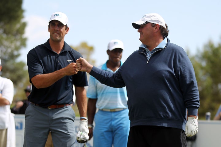 Rodgers and Baumgartner fist-bump at a golf tournament in 2014.