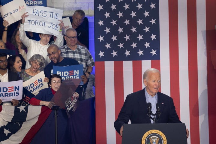 An audience member holds a sign calling on President Joe Biden to "pass the torch" during a campaign rally at Sherman Middle School on July 5, 2024 in Madison, Wisconsin. 