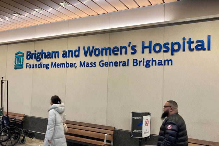 People walk past a sign at Brigham and Women's Hospital in Boston, on Jan. 3, 2024.